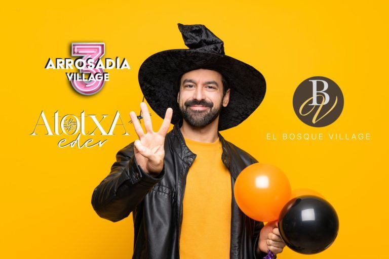 Man with witch hat holding black and orange air balloons for halloween party happy and counting three with fingers